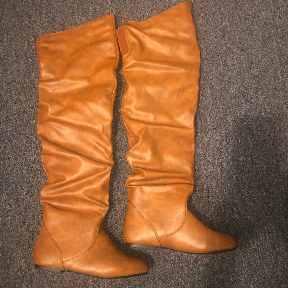 Thigh high brown leather boots